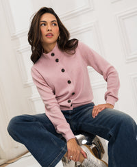 Woman wears the Merino turtleneck cardigan LES SEIZE by PLEIN PUBLIQUE in a bright room.