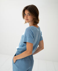 Light blue linen summer sweater, relaxed fit, shown in a bright room.