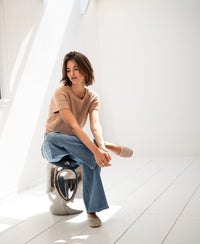 Linen blend LE SOLEIL soft camel summer sweater shown in a bright, minimalist room.