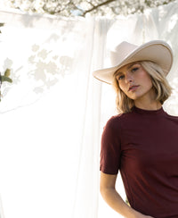 Chestnut bamboo turtleneck top by PLEIN PUBLIQUE, shown in sunlight.