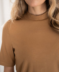 Bamboo turtleneck top in gold yellow by PLEIN PUBLIQUE, shown from shoulders to chin.