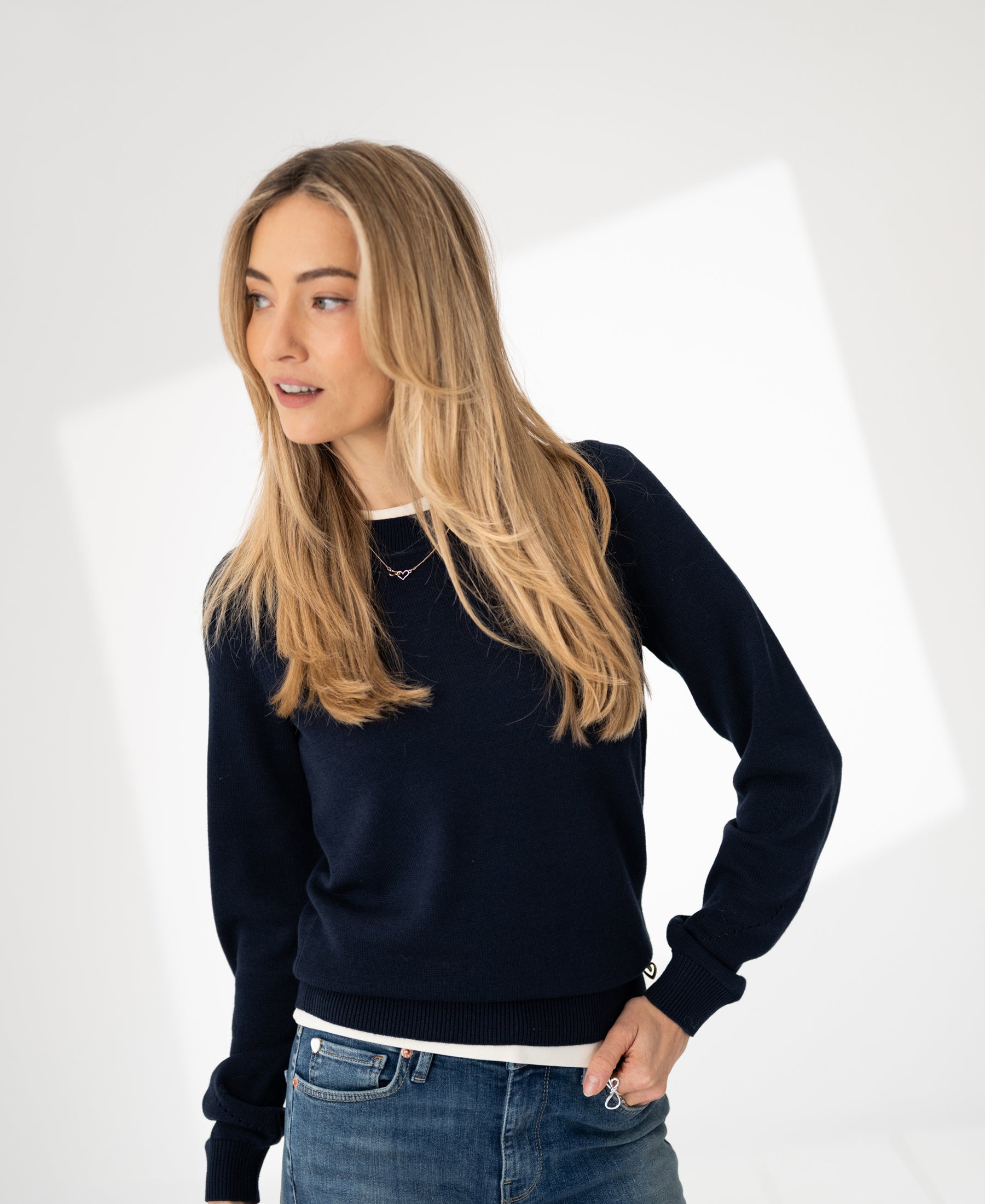 Navy merino blend sweater by PLEIN PUBLIQUE shown on a model looking to the side.