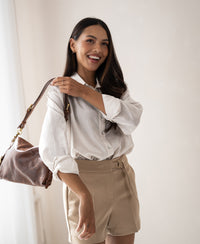 Woman indoors wears Dunne oversized blouse by La Soyeuse Kit.