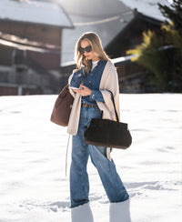 Front view of woman wearing stonewash Tencel jeans blouse, walking outdoors.