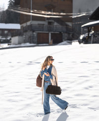 Blue stonewash Tencel denim blouse, front view, worn by a model outdoors in snowy setting.
