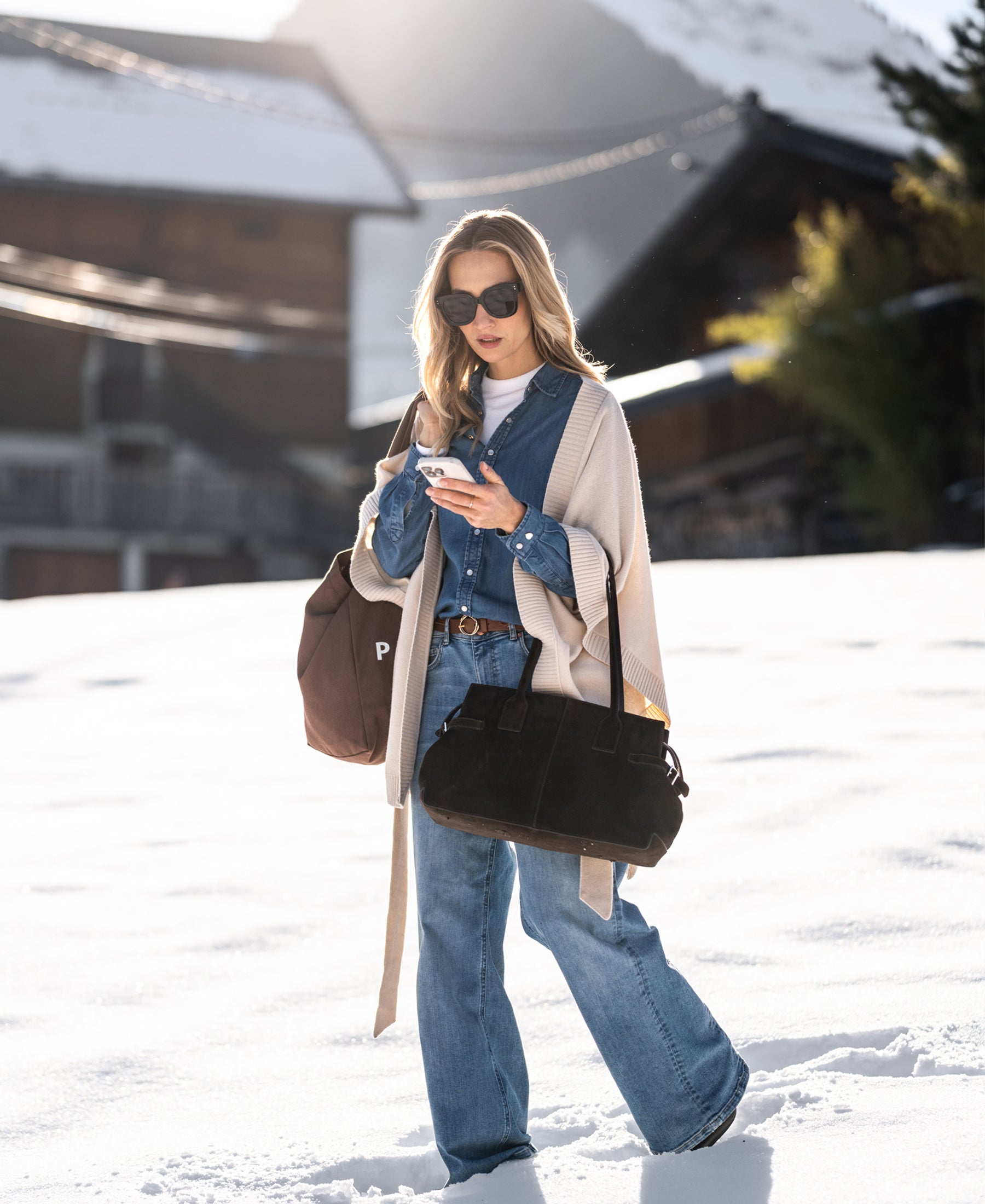 Tencel denim blouse in light blue, front view, shown outdoors against snowy background and wooden cabins.