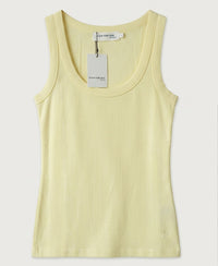 Soft yellow sleeveless ribbed jersey top with scoop neck, shown flat.