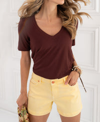 Chestnut and yellow shorts made from bamboo blend, shown indoors.