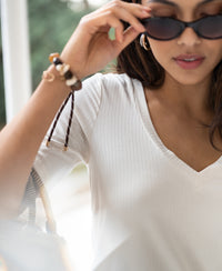 Woman wearing a cream bamboo T-shirt from PLEIN PUBLIQUE, LES VERSAILLES style.