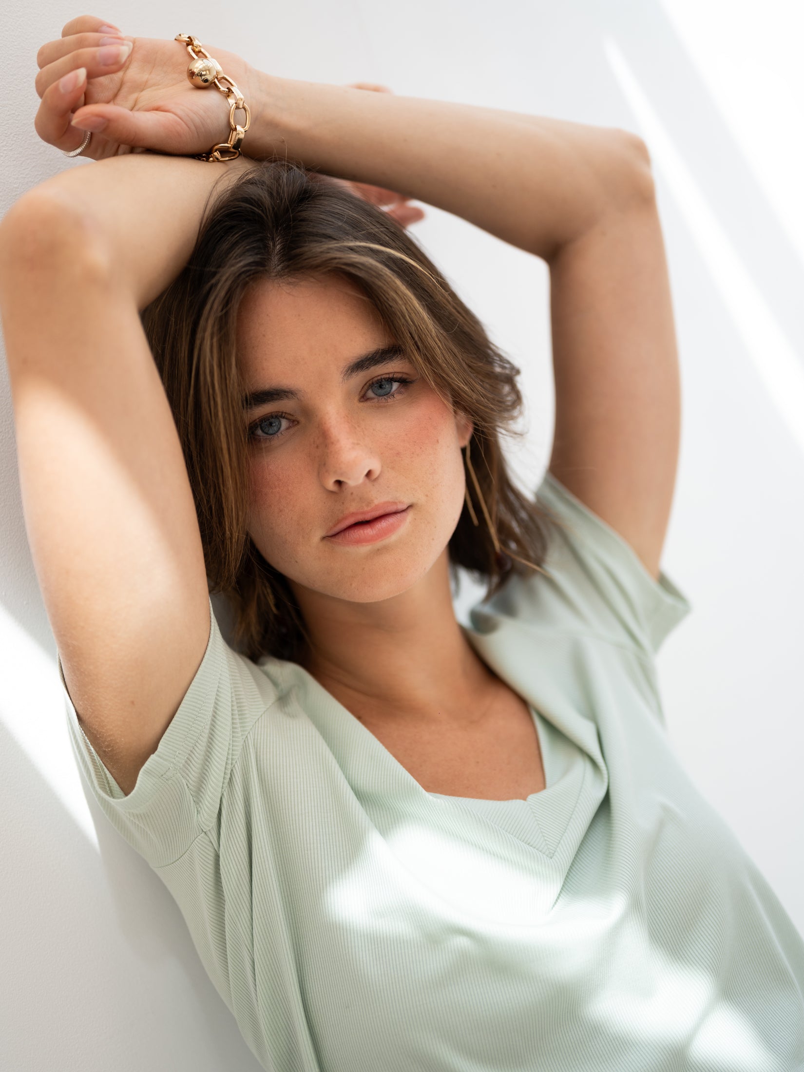 Light green Lyocell T-shirt from PLEIN PUBLIQUE, shown on model in front of a white wall.