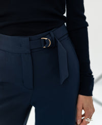 Close-up of dark blue LA WENDE trousers by PLEIN PUBLIQUE.