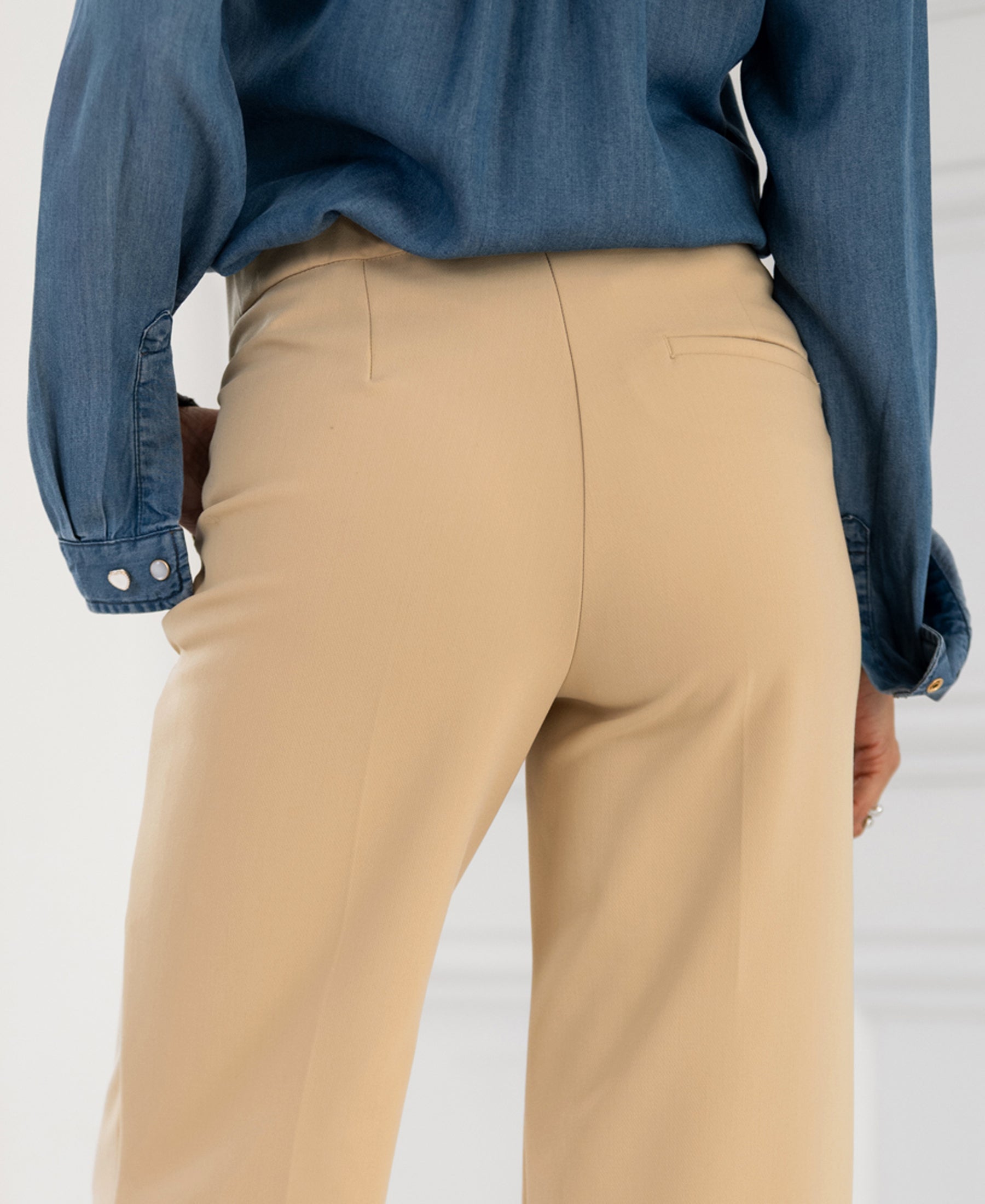 LA WENDE Sand Trousers from PLEIN PUBLIQUE, seen from the back at hip height.