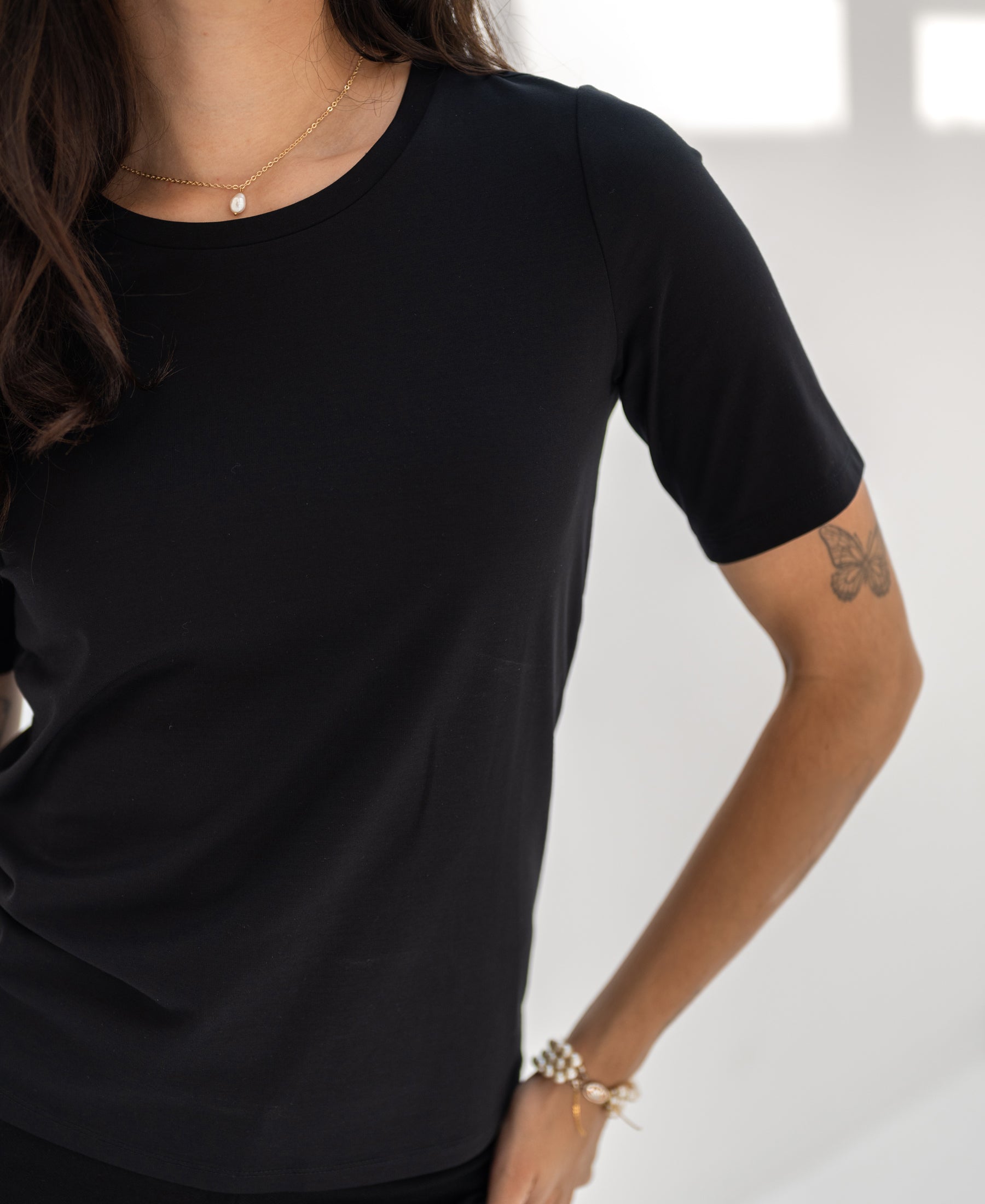 Woman wearing a black PLEIN PUBLIQUE Travel T-shirt 